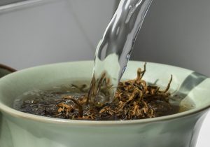 water pouring on tea leaves